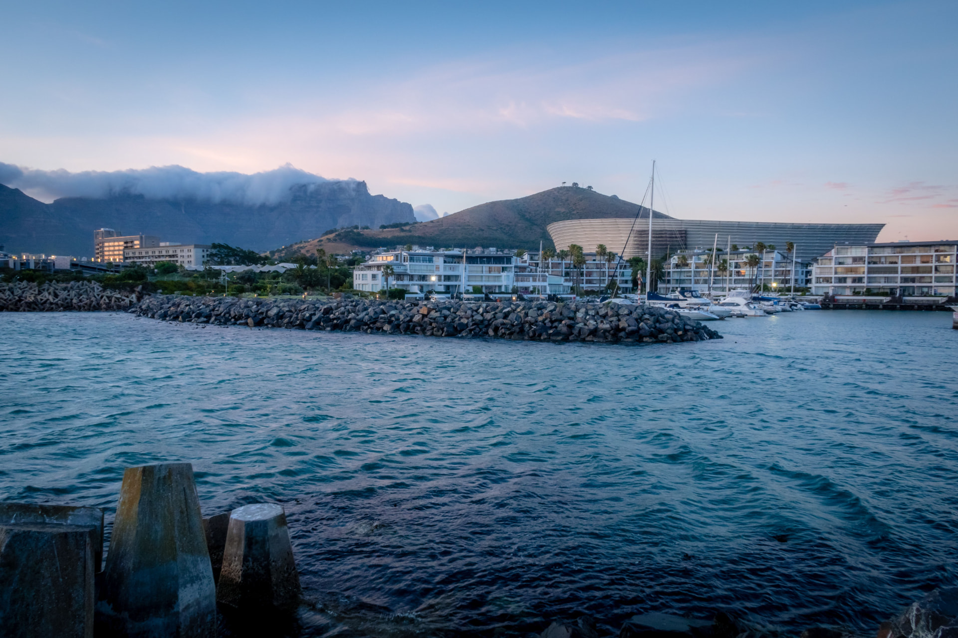 Cape Town waterfront at dusk with Table Mountain behind the city