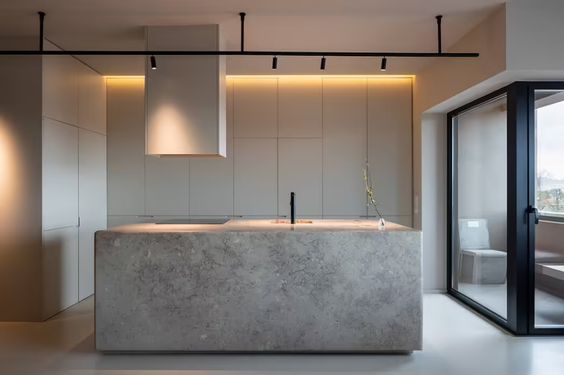 Monolithic stone island in a minimal kitchen